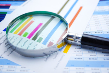 Magnifying glass on charts graphs spreadsheet paper. Financial development, Banking Account, Statistics, Investment Analytic research data economy, Stock exchange trading, Business office company meet