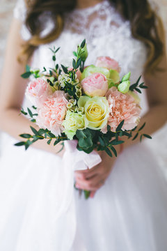 Bride holds wedding bouquet in her hands