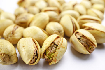 Pistachio nuts on white background : healthy food concept.