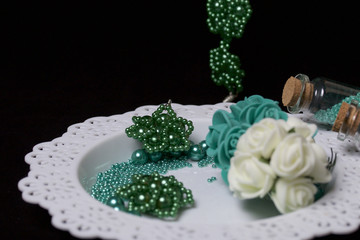 Bead jewelery. DIY jewelry. Necessary accessories. Beads and ready-made earrings. Tools and fixtures. On a black background.