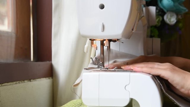 Close up on a sewing machine showing process.