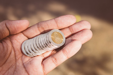 Fototapeta premium Closeup stack coins of Thai baht on hand