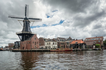 The eight-sided smock mill De Adriaan on the river De Spaarne in Haarlem