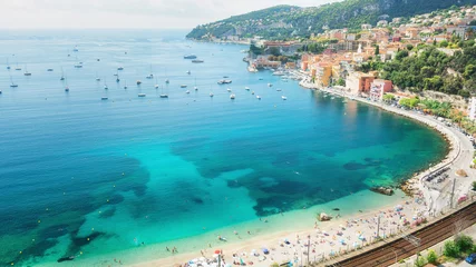 Glasschilderij Villefranche-sur-Mer, Franse Riviera Bathers enjoy at the beach of the beautiful bay of Villefranche-sur-Mer on the Cote D'Azur