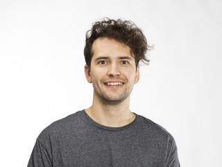 Portrait of a handsome man smiling at the camera. Isolated on white