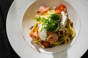 Tagliatelle with shrimps, arugula, tomatoes and Philadelphia cheese.