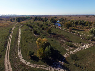 Fototapeta na wymiar Remains of an old abandoned road.Aerial view of the countryside. Near Kiev