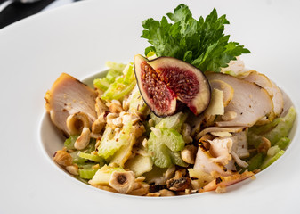 Grilled chicken breast salad with figs, green apple, celery, nuts and Parmesan.