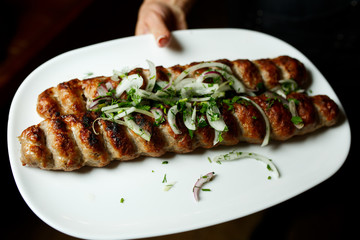 Lula kebab with vegetables. Minced mutton chop on white plate