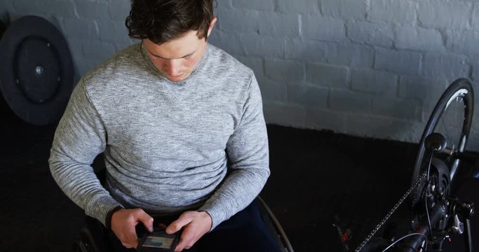 Disabled man using mobile phone at workshop 4k