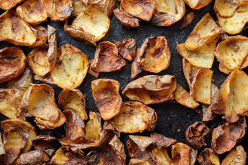Baked potato skin crisps on a tray.