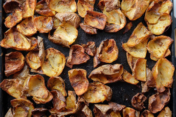 Baked potato skin crisps on a tray.