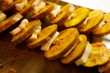 Sliced potatoes with bacon on a skewer