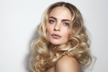 Young beautiful blonde woman with long curly hair