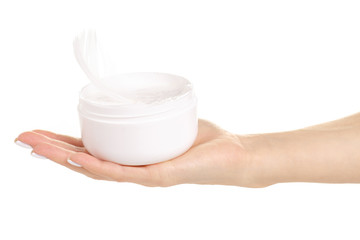 White feather in the female hand beauty care skin on a white background isolation