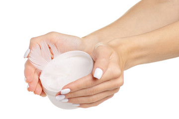 White feather in the female hand beauty care skin on a white background isolation