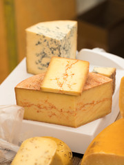 Selection of different cheeses on a food market stall