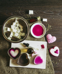 Making soap from pour and melt soap base concept. Soap making ingredients on brown wooden background. melt and pour method, buy a soap base that’s already been made and cured. Copy space. Hobby.