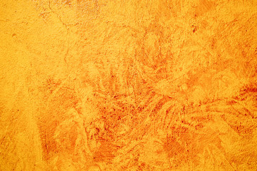 Textured orange painted concreet wall, abstract background