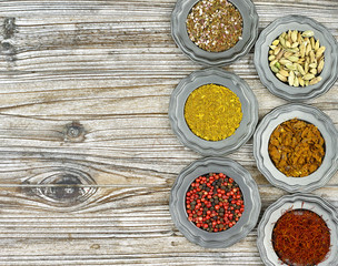 Flat lay concept, copy space, mixed dried spices in vintage tin bowls top view