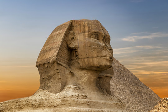 Spinx face on the Giza pyramid background at sunset, Cairo, Egypt
