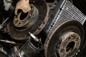 Pile of used automotive parts close-up. Heap of old cars details, auto-waste.