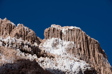Fototapeta na wymiar Sand dunes with salt deposits in the Atacama Desert, Chile on a sunny day with blue sky