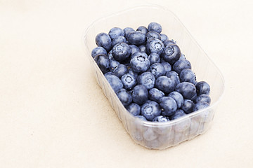Blueberries on the craft background.