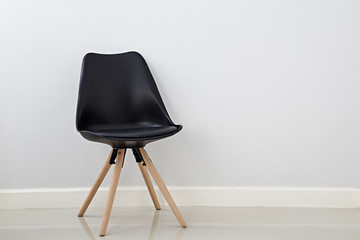 Cozy chair on wall background