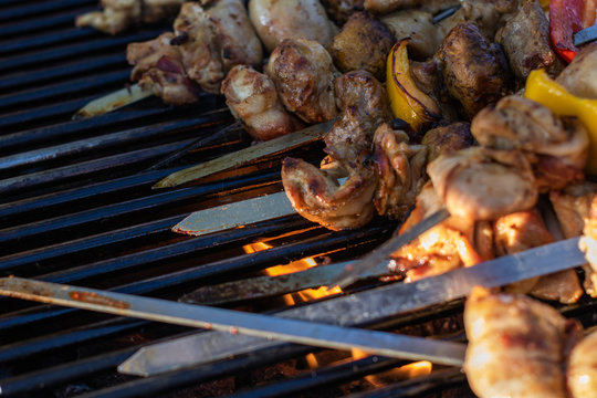 Close up of Chicken, Beef, Bacon and Potatoes Skewers on  Barbecue