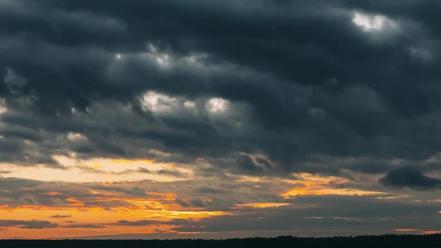 Sunset Sky. Bright Dramatic Sky With Fluffy Clouds. Yellow, Orange, Blue And Magenta Colours. Time Lapse Time-lapse