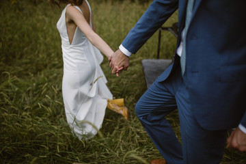 married couple holding hands and walking