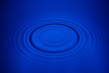 Closeup blue wave water rings macro, Circle reflections in pool.