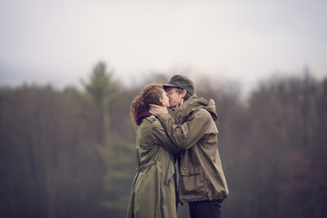 Couple kissing on field against sky © Cavan for Adobe