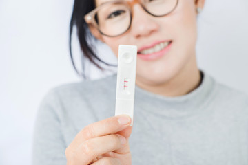 The smiling faces of Asian women are happy when they are having children ,Focus on hand