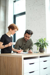 business woman and business man talking about deals at meeting in modern office and sign documents...
