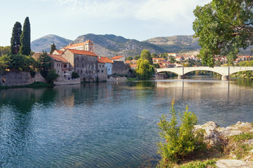 Obraz premium Ancient town on the river bank. Bosnia and Herzegovina, Republika Srpska. Trebisnjica river and Old Town of Trebinje, autumn