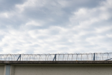 Prison wall with barbed wire