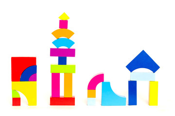 Children's multi-colored wooden blocks cubes toys on a white background. Multicolored figures.
