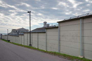 Fototapeta na wymiar Prison wall with barbed wire