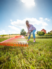 Unusual angle of woman raking leaves