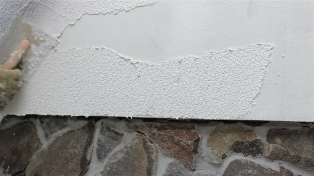 Finishing facade plaster,the builder plaster the facade with decorative plaster