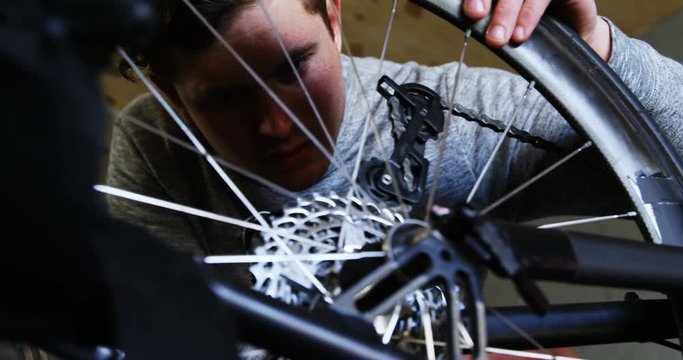 Disabled man repairing wheelchair at workshop 4k
