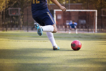 Cropped image of man playing soccer at field © Cavan for Adobe