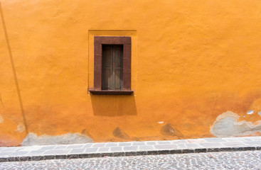 Street view in Mexico on sunny day with traditional architecture window