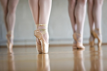 Low section of ballet dancers practicing in studio © Cavan for Adobe