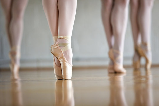 Low section of ballet dancers practicing in studio