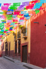 Colorful paper flags over street