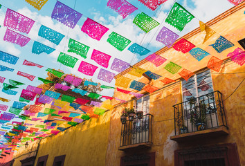 Colorful paper flags over street