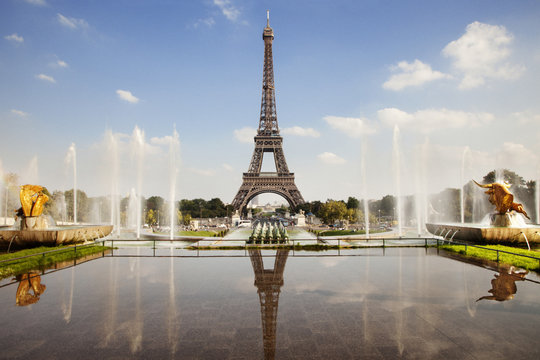 Reflection of Eiffel Tower seen in pond against sky